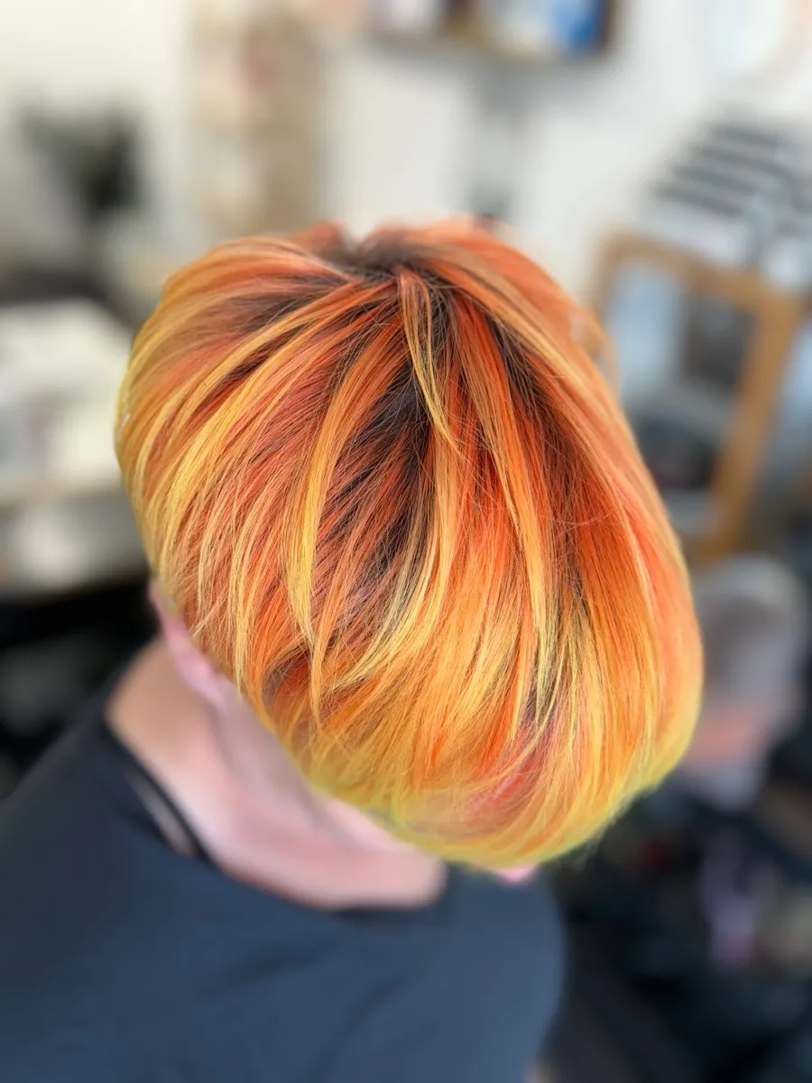 Multi-tonal warm blonde woven through a sharp bob